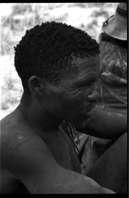 Portrait of a man sitting seen from the side, close-up