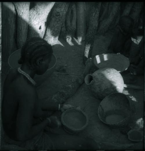 Woman sitting and making a pot