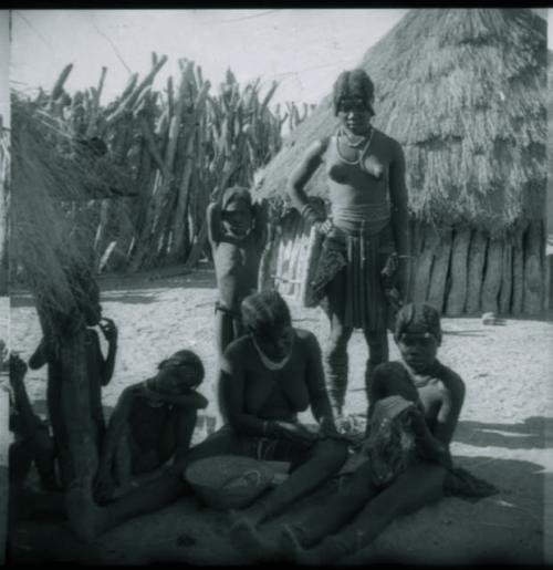 Group of women working on part of a garment or ornament