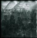 Women standing and sitting in front of fence (double exposure)