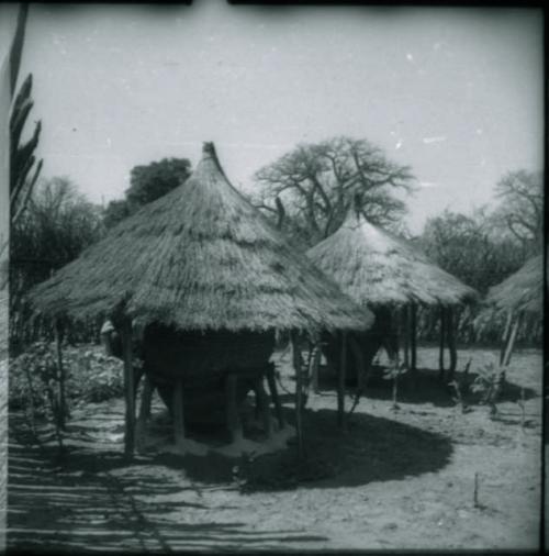 Two storage baskets with thatched roofs