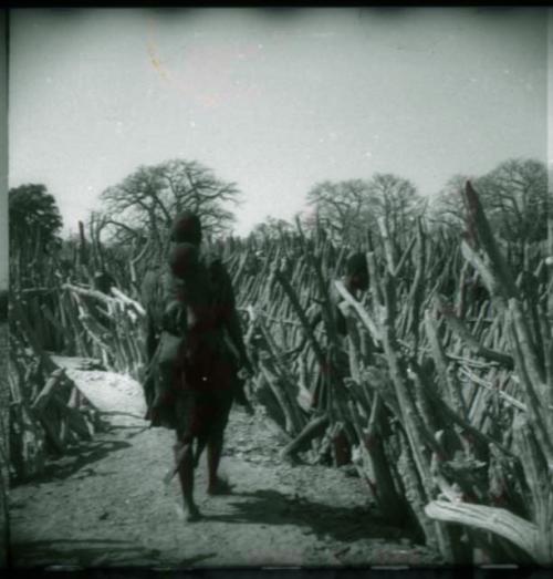 Two women walking inside their kraal