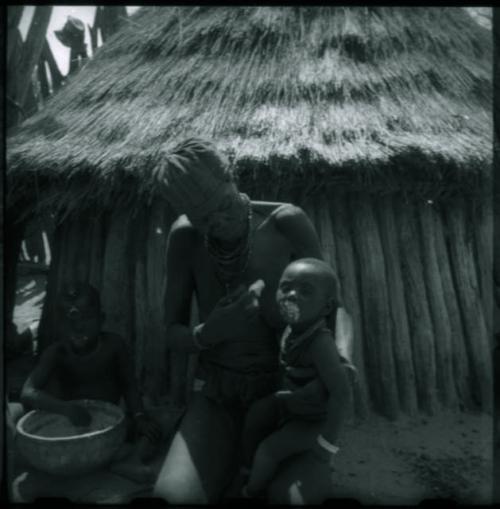 Elderly woman feeding two children