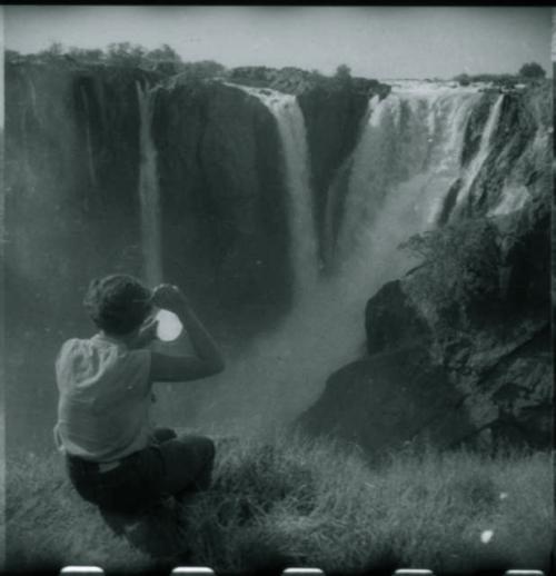 Elizabeth Marshall Thomas cutting her hair in front of the main jet of Ruacana Falls