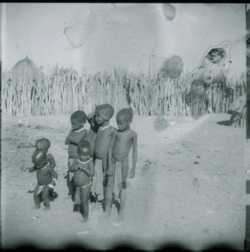 Group of children standing inside their kraal