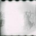 Man standing in front of a storage basket (overexposed)