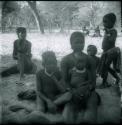 Women sitting, with children sitting and standing