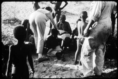 Lorna Marshall giving out gifts to a group of people after the Eland Dance