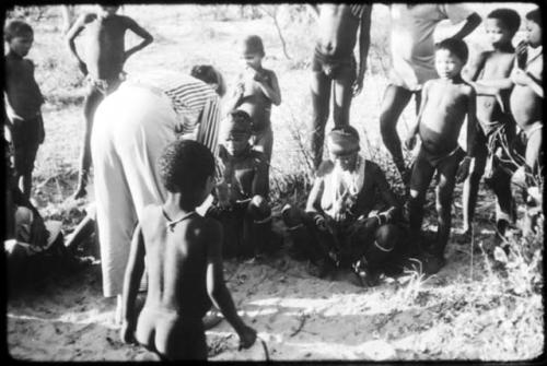 Lorna Marshall giving out gifts to a group of people after the Eland Dance