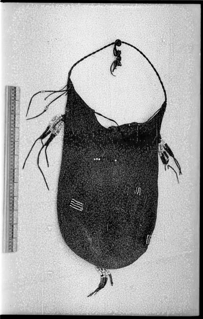 Animal-skin bag ornamented with beads and a ruler for measurement