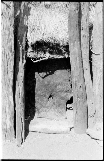 Doorway with a leather curtain and a log threshold