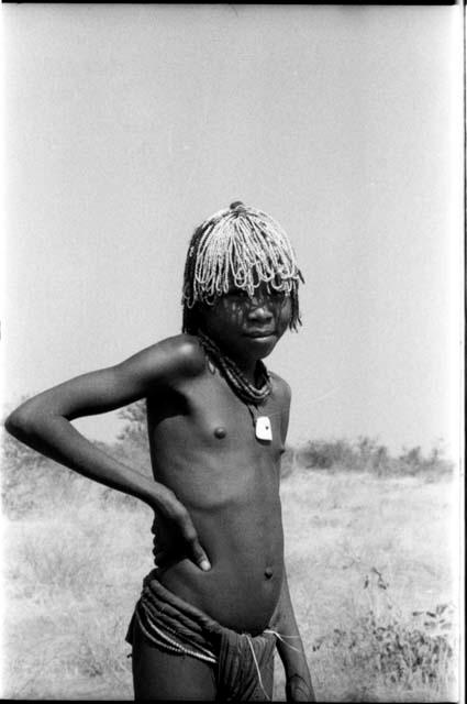 Girl wearing beads in her hair, standing