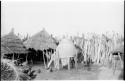 Large storage basket in a Hinga kraal supported by wooden poles and two thatched roofs supported by wooden poles