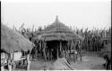 Large storage basket in a Hinga kraal supported by wooden poles underneath a thatched roof