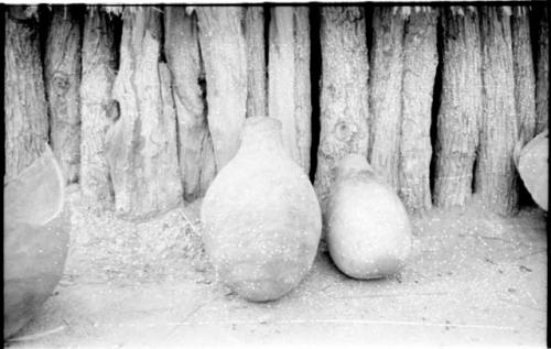 Two pots resting on the ground in a Hinga kraal