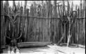 Platforms on wooden supports within a fenced enclosure where chief receives guests