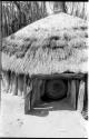 Hut in Ombandia kraal with a basket in the entrance