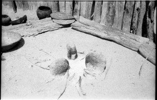 Three overturned pots in the ashes of a fire in an Ombandia kraal