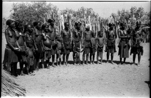 Women and children standing in a semi-circle