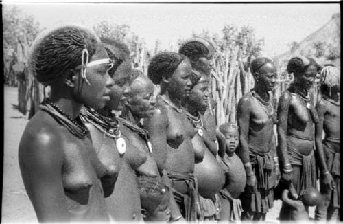 Women and children standing in a semi-circle, close-up