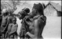 Women and children standing in a semi-circle, close-up