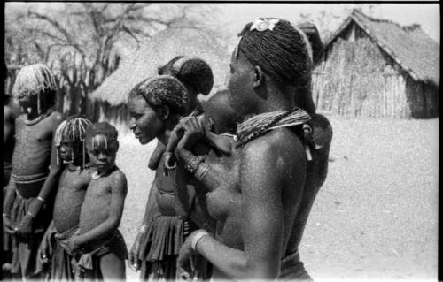 Women and children standing in a semi-circle, close-up