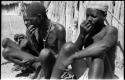 Three men sitting and taking snuff