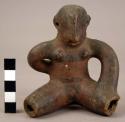 Female figurine of Red and Black Line Ware with something on the back.  Suspensi