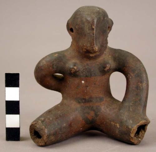 Female figurine of Red and Black Line Ware with something on the back.  Suspensi