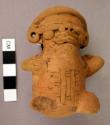 Torso of red incised humpback; legs broken; one hand holding vessel to shoulder;