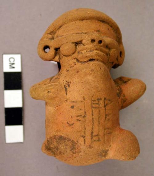 Torso of red incised humpback; legs broken; one hand holding vessel to shoulder;