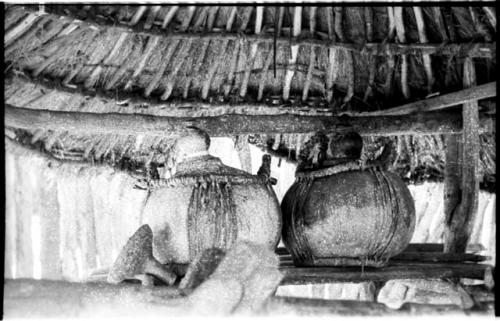 Churns under a thatched roof