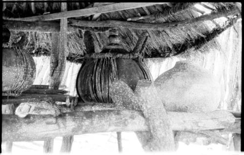 Churns under a thatched roof