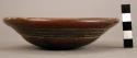 Unpainted bowl with dark red lines incised in the form of a rectangle and a wavy