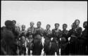 Women standing in a  semi-circle, clapping for a dance