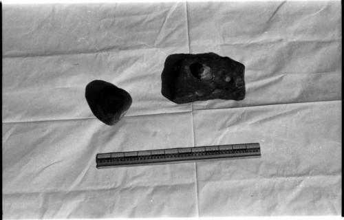 Three pounding stones, including one for being pounded on, and a ruler for measurement