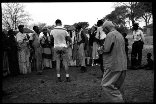 Dance in progress, men and women clapping; Nicholas England and Laurence Marshall recording