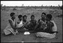 Group of young women sitting, playing a dandiri and singing