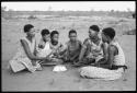 Group of young women sitting, playing a dandiri and singing