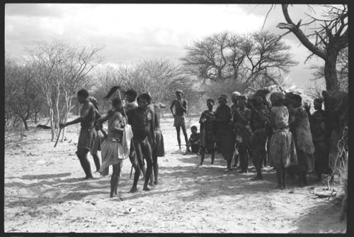 Group of people singing and dancing, a group standing to the side