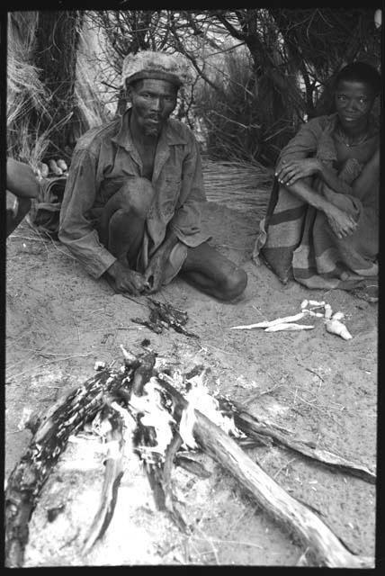 Da/ho and //?Axa, Da/ho's wife, sitting by a fire