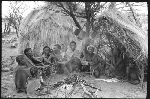 From left to right: a young boy; "old Xama"; /Naoku, wife of //Xoxa; ǂNobe; Kã?//a, husband of ǂNobe; //Kao/õ; Da/ho; //?Axa, wife of Da/ho; and a boy sitting in front of Da/ho's skerm