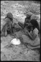 Group of women sitting and playing the dandiri