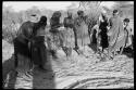 Group of women singing and clapping in a line