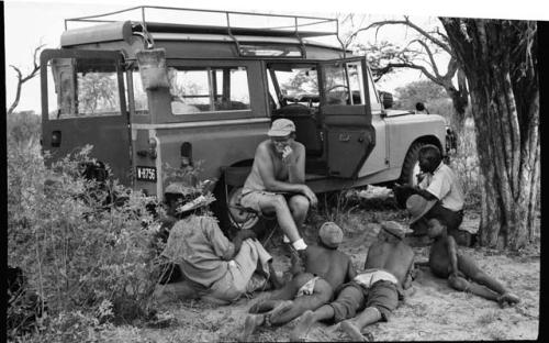 Nicholas England and a group of people sitting by the Land Rover