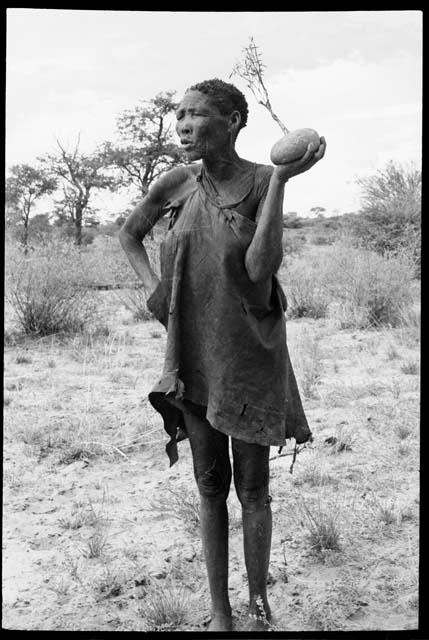 Woman standing and holding a root