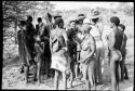 Group of men and women standing around Wilhelm Camm and Lorna Marshall