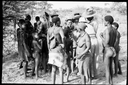 Group of men and women standing around Wilhelm Camm and Lorna Marshall