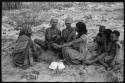 Group of women sitting and playing the dandiri