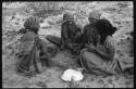 Group of women sitting and playing a dandiri
